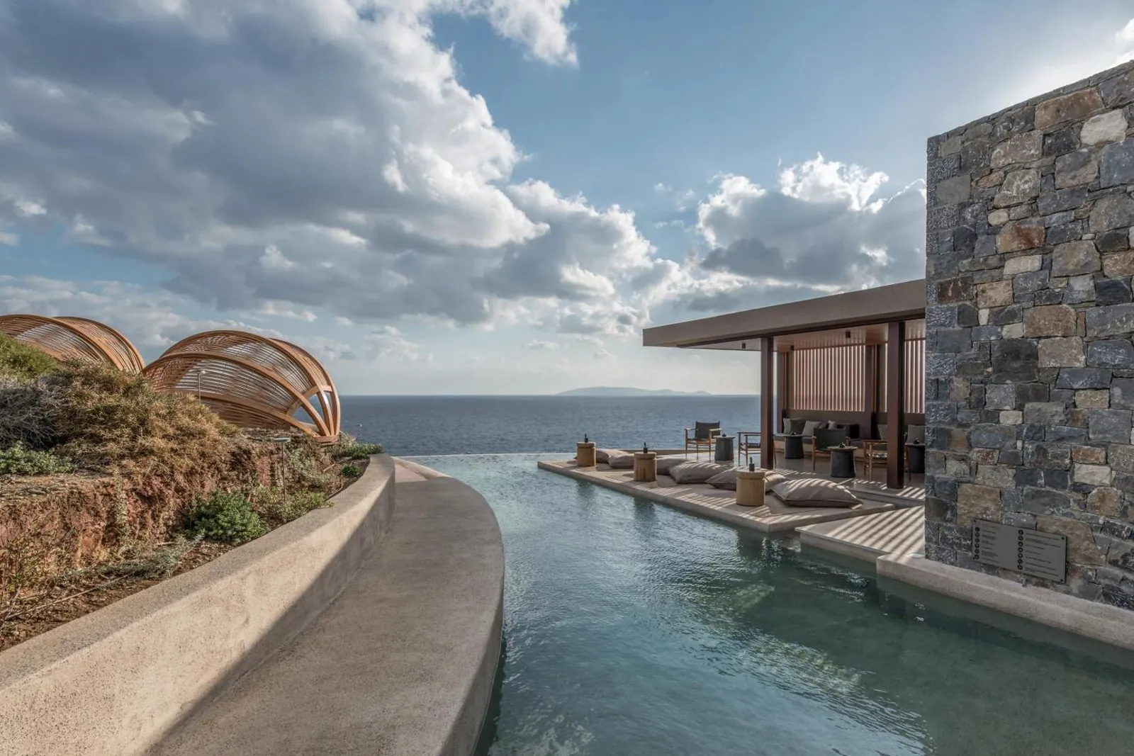 Saltwater infinity pool on the cliff at Acro Suites, with the Cretan Sea beyond the edge
