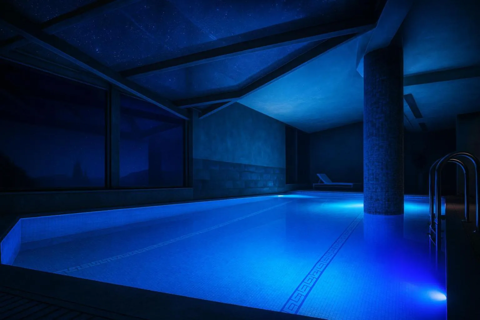 Indoor pool in low blue light beside a stone column