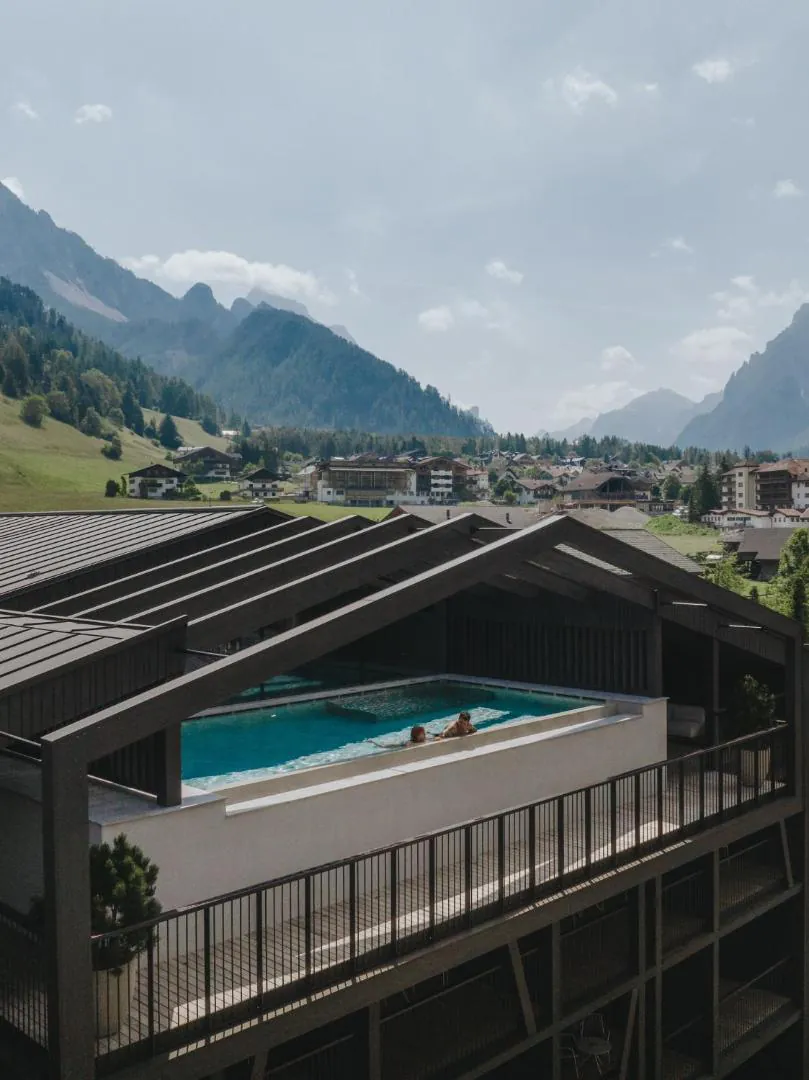 AMA Stay's rooftop pool seen from above over San Vigilio di Marebbe