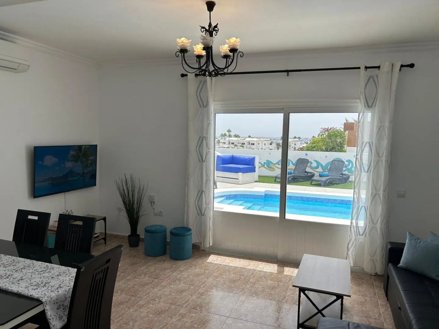 Lounge with glass doors looking straight onto the pool