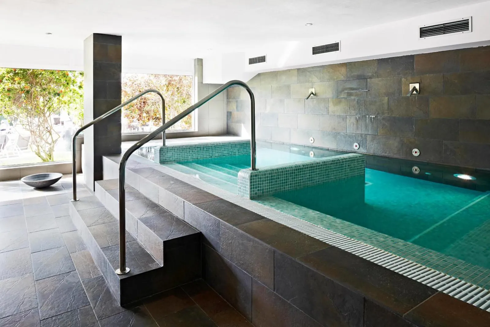 Small spa pool with stone steps
