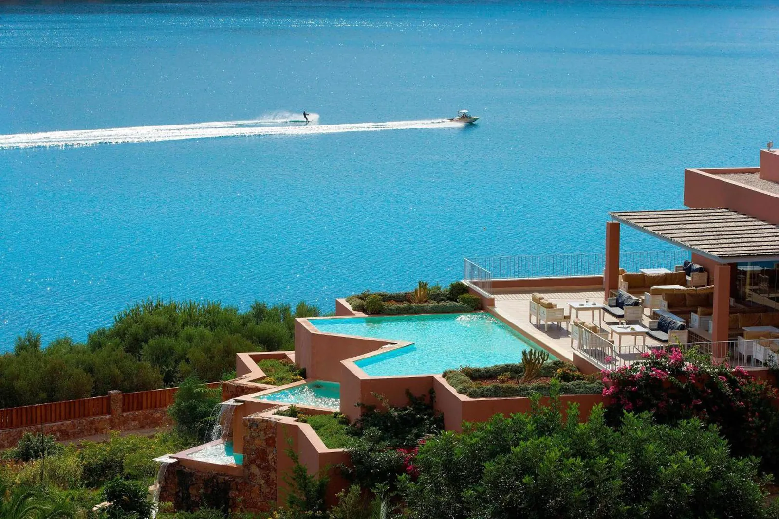 Pools stepping down the hillside towards the bay at Domes of Elounda