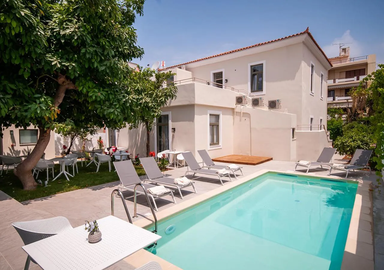 Outdoor pool and loungers in the garden of the restored mansion at Epavli