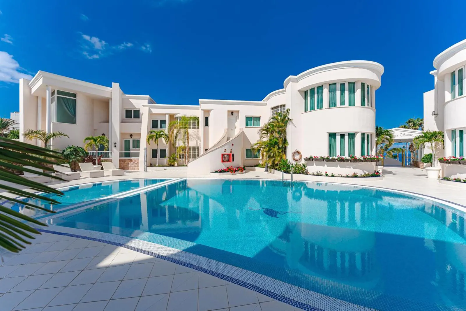 Pool and sun terrace between the white suite blocks