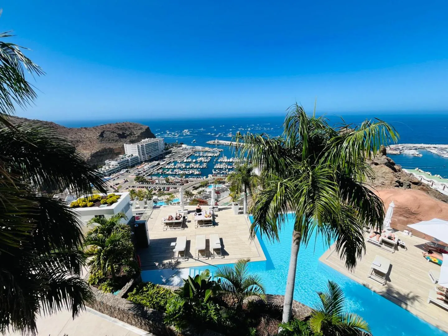 Pool terrace above Puerto Rico de Gran Canaria with the marina and the ocean below