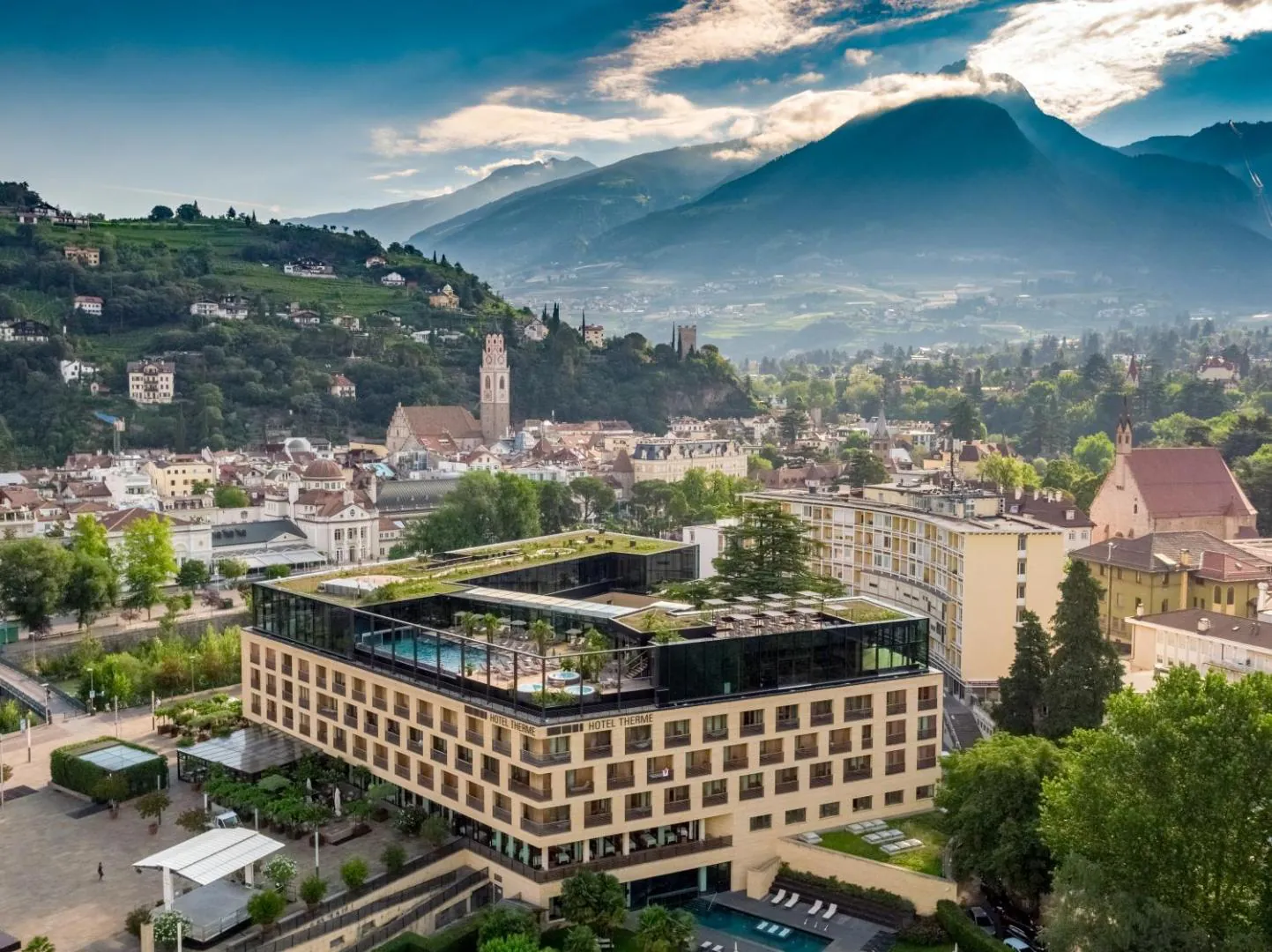 Aerial view of Hotel Therme Meran with its rooftop pool in the centre of Merano