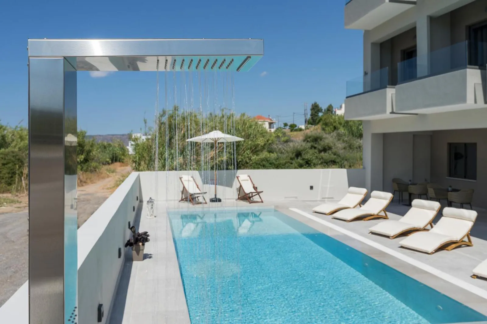 Outdoor shower and loungers along the pool deck