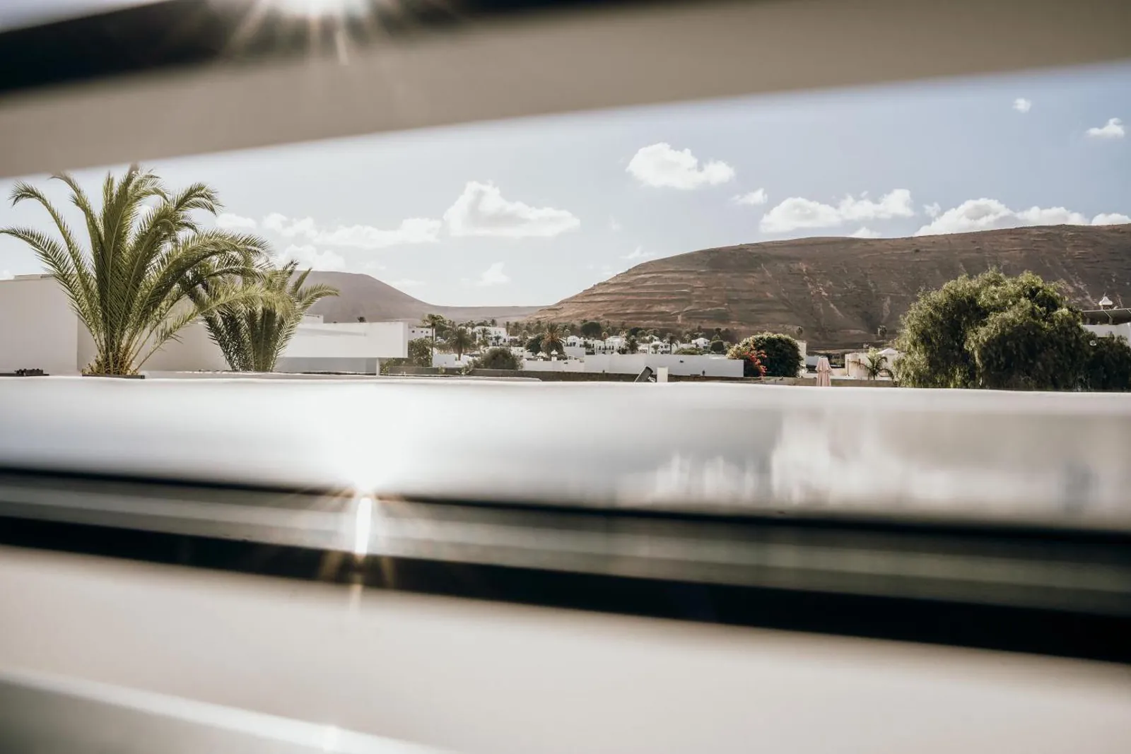 View from the villa over palms and Yaiza's volcanic hills