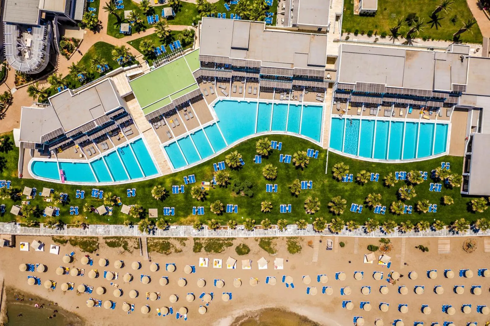 Long curved pool between the hotel wings and the beach at Lyttos Beach