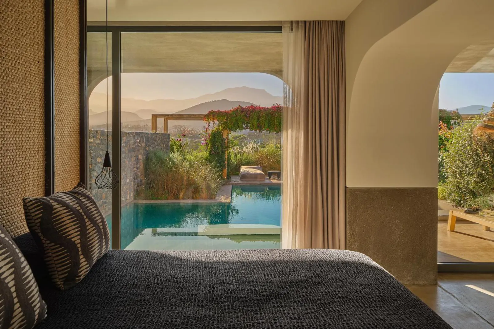 Suite bedroom opening straight onto its private pool