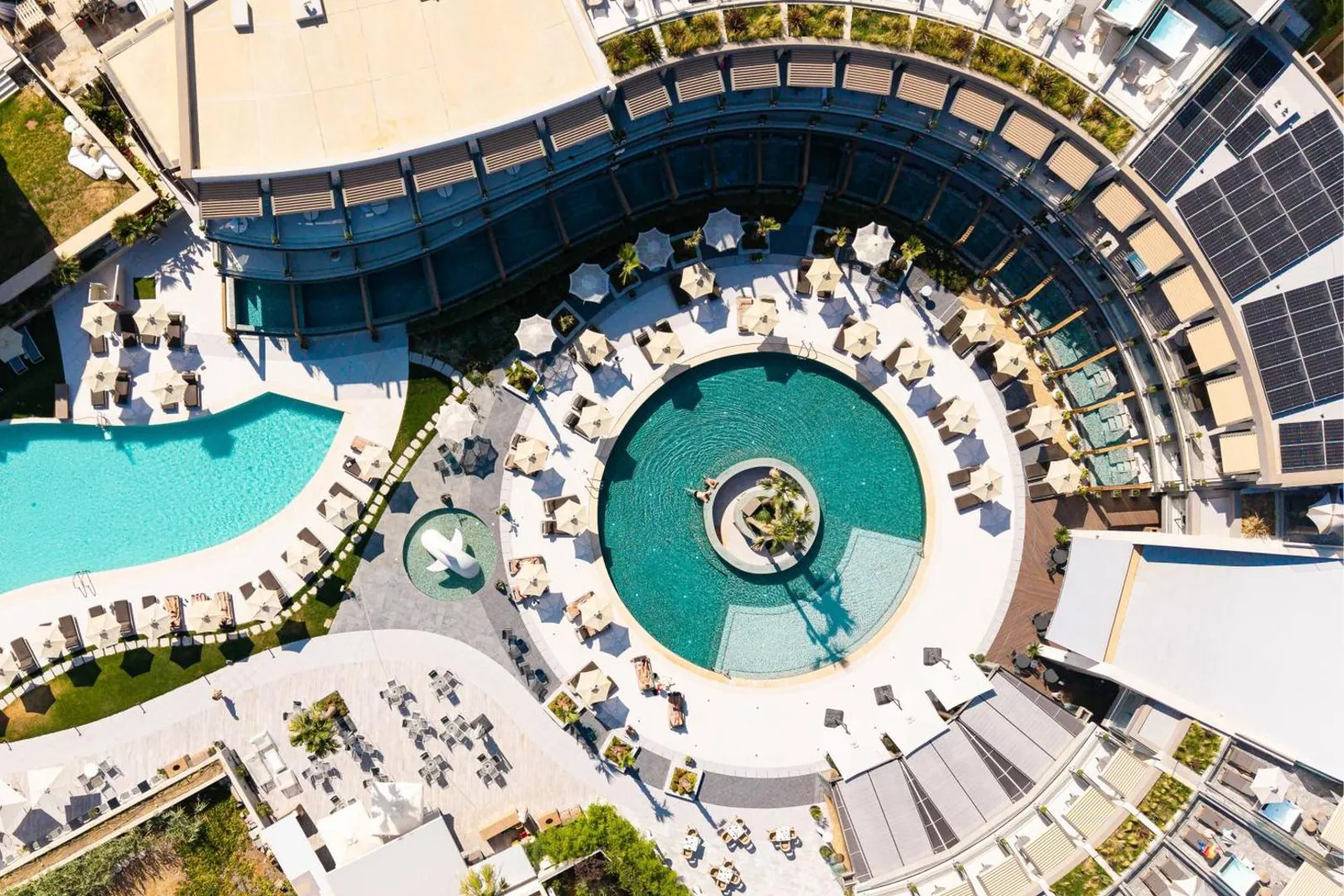 Aerial view of the spiral-shaped outdoor pools and sun terraces