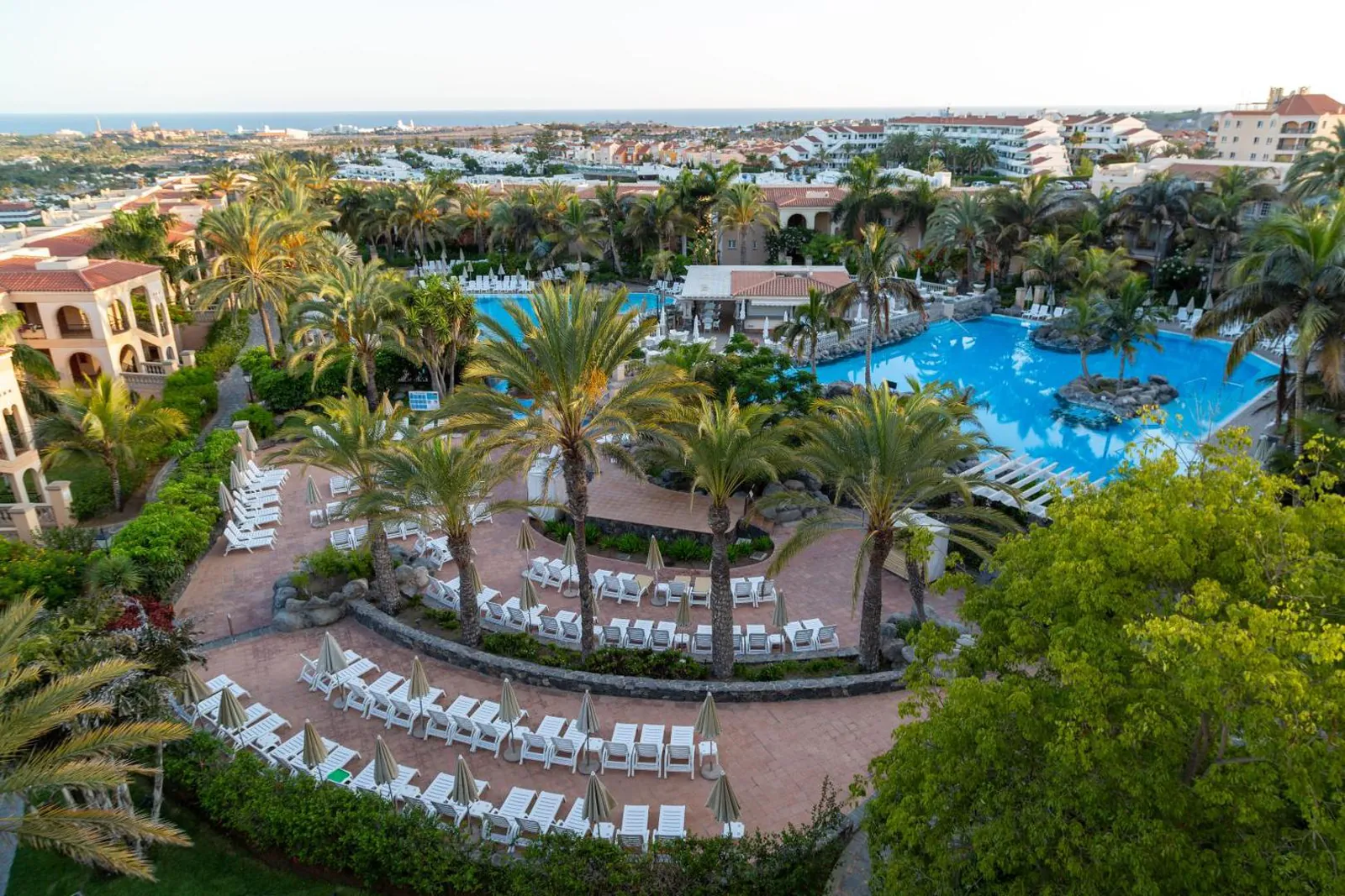 Aerial view of rows of sun loungers around the pool garden