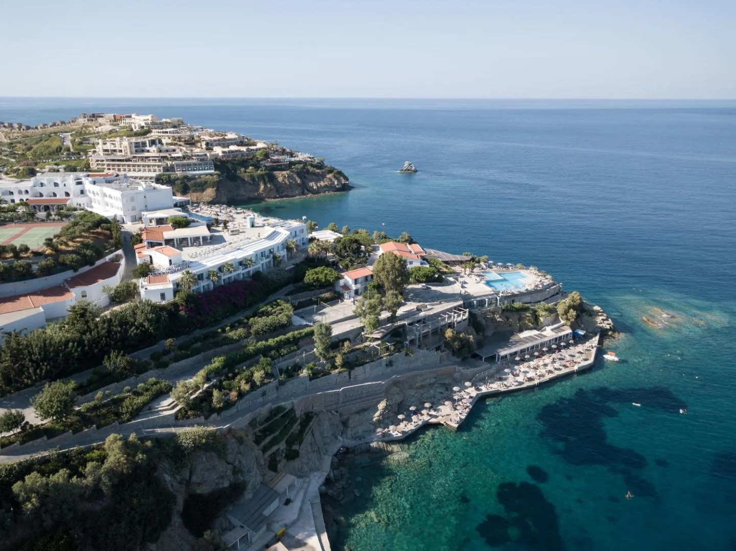 The resort spread along the Agia Pelagia peninsula, with the saltwater pool terrace above the sea