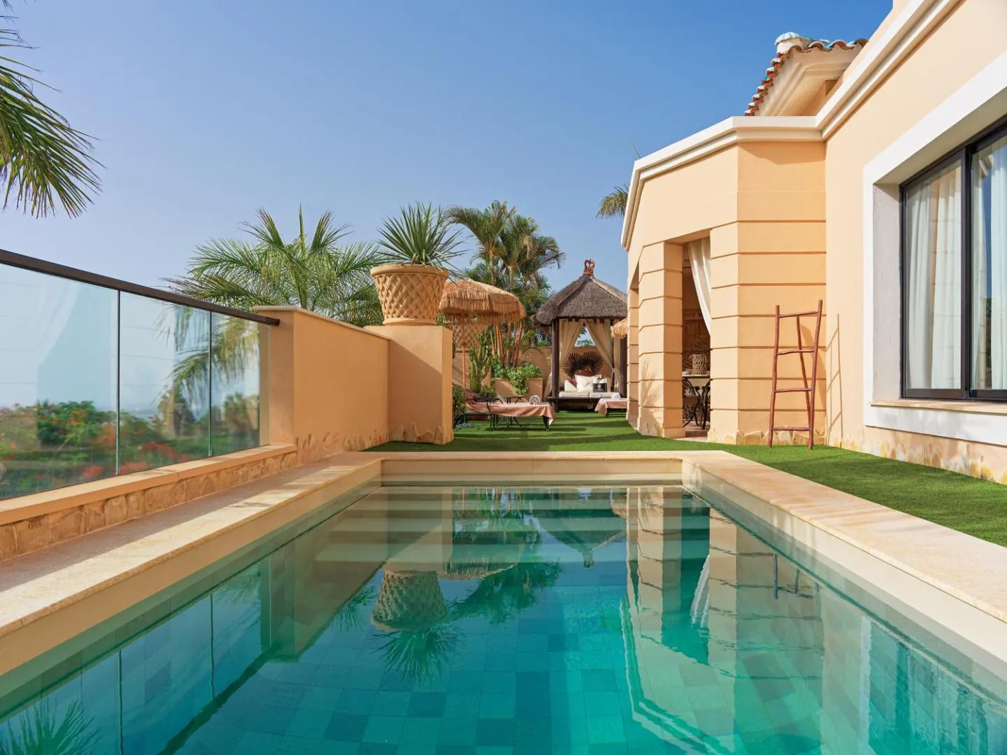 Villa terrace with a private heated pool and glass balustrade at Royal Garden Villas, Adeje