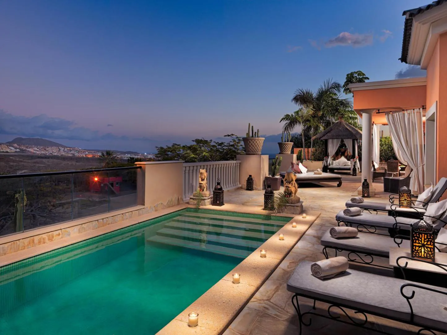 Private villa pool lit at dusk with the Atlantic beyond, Royal Garden Villas