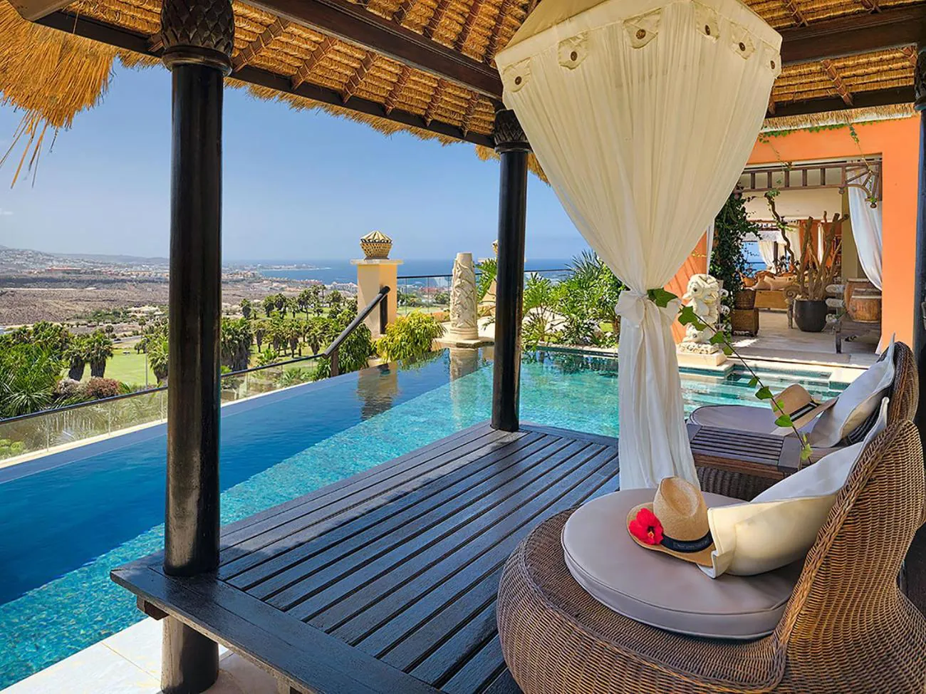 Villa pool with a Balinese daybed and sea views at Royal Garden Villas