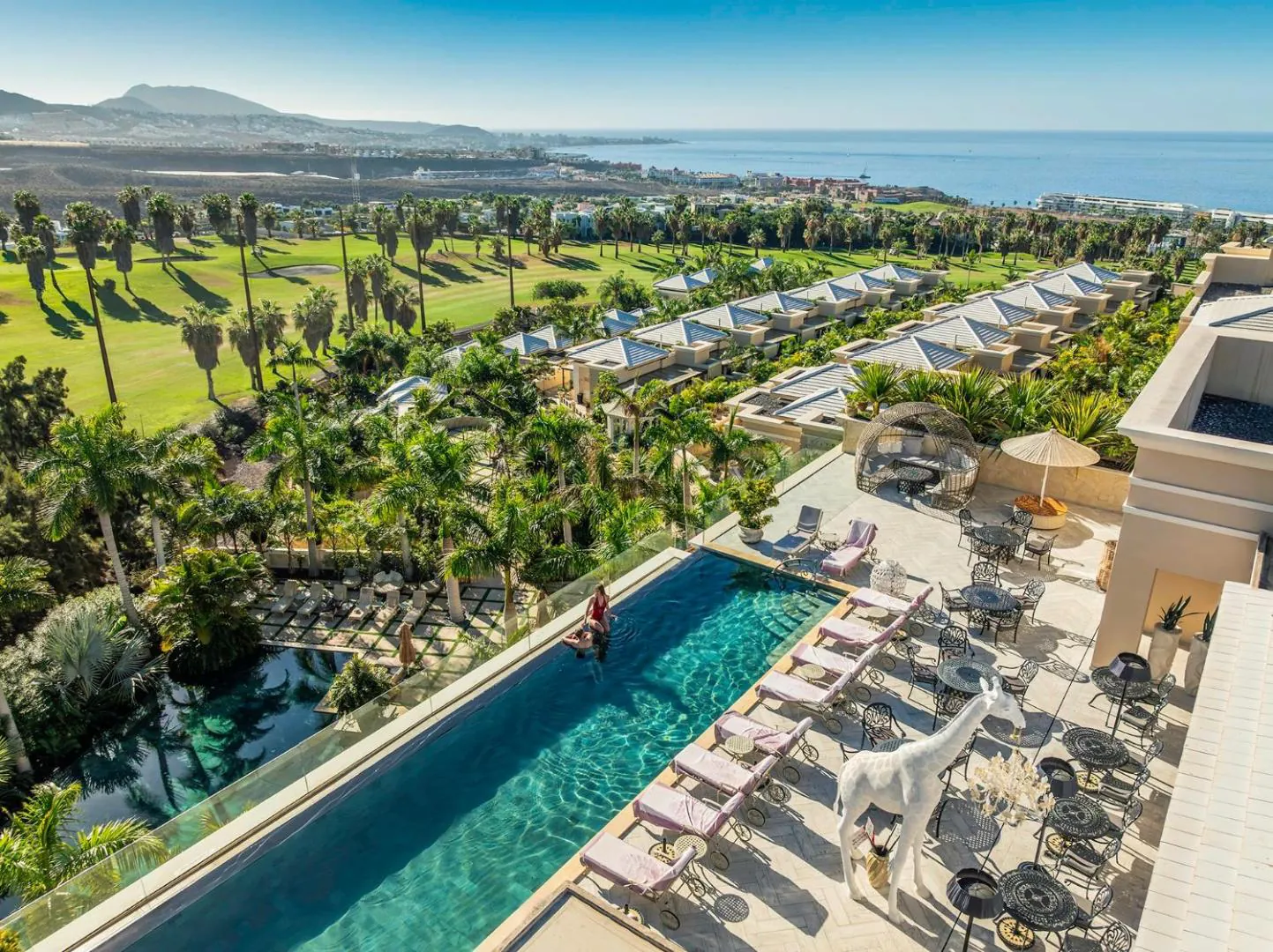 Rooftop infinity pool at Royal River seen from above, with Costa Adeje and the Atlantic beyond