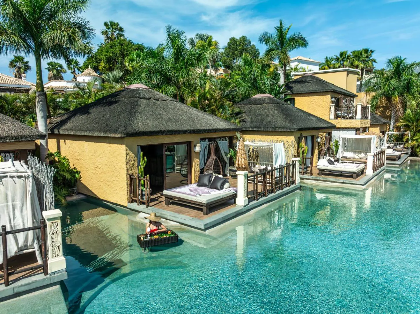 Thatched villa with its own pool opening onto the river pool at Royal River