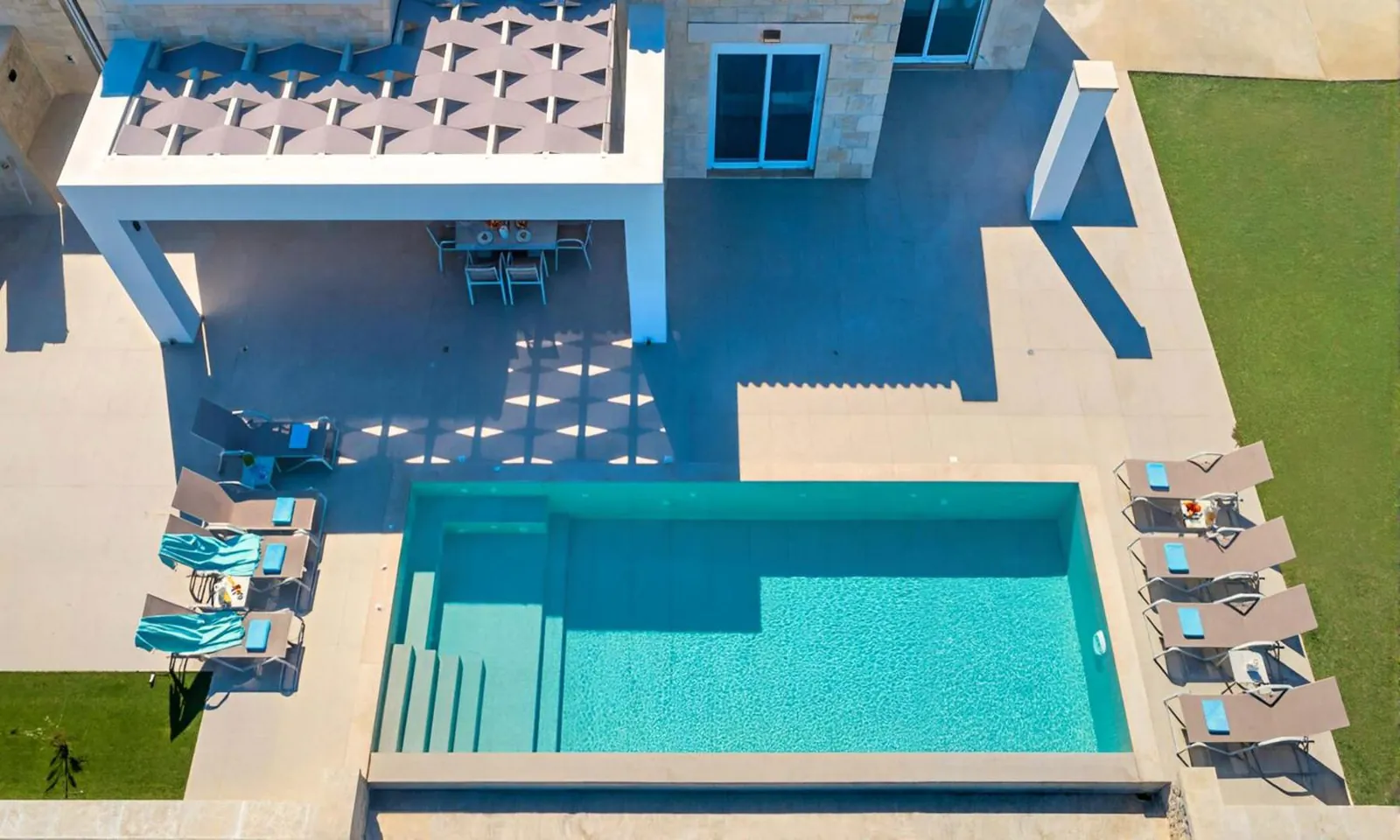 Aerial view of a villa's private pool and covered terrace